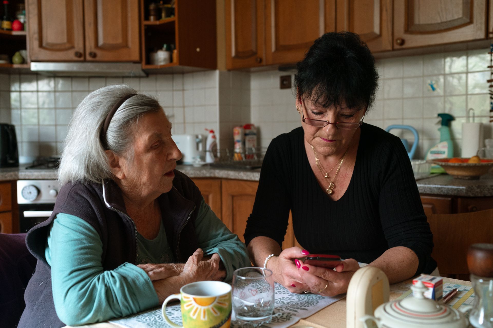 Two women spending time together at a kitchen table.